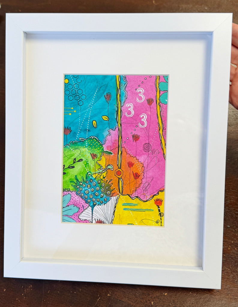 an original abstract painting on paper in a white glass front frame