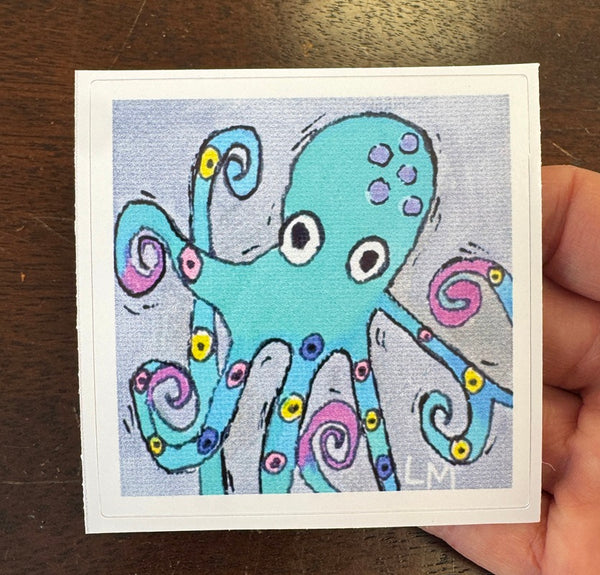 whimsical octopus sticker being held by a hand