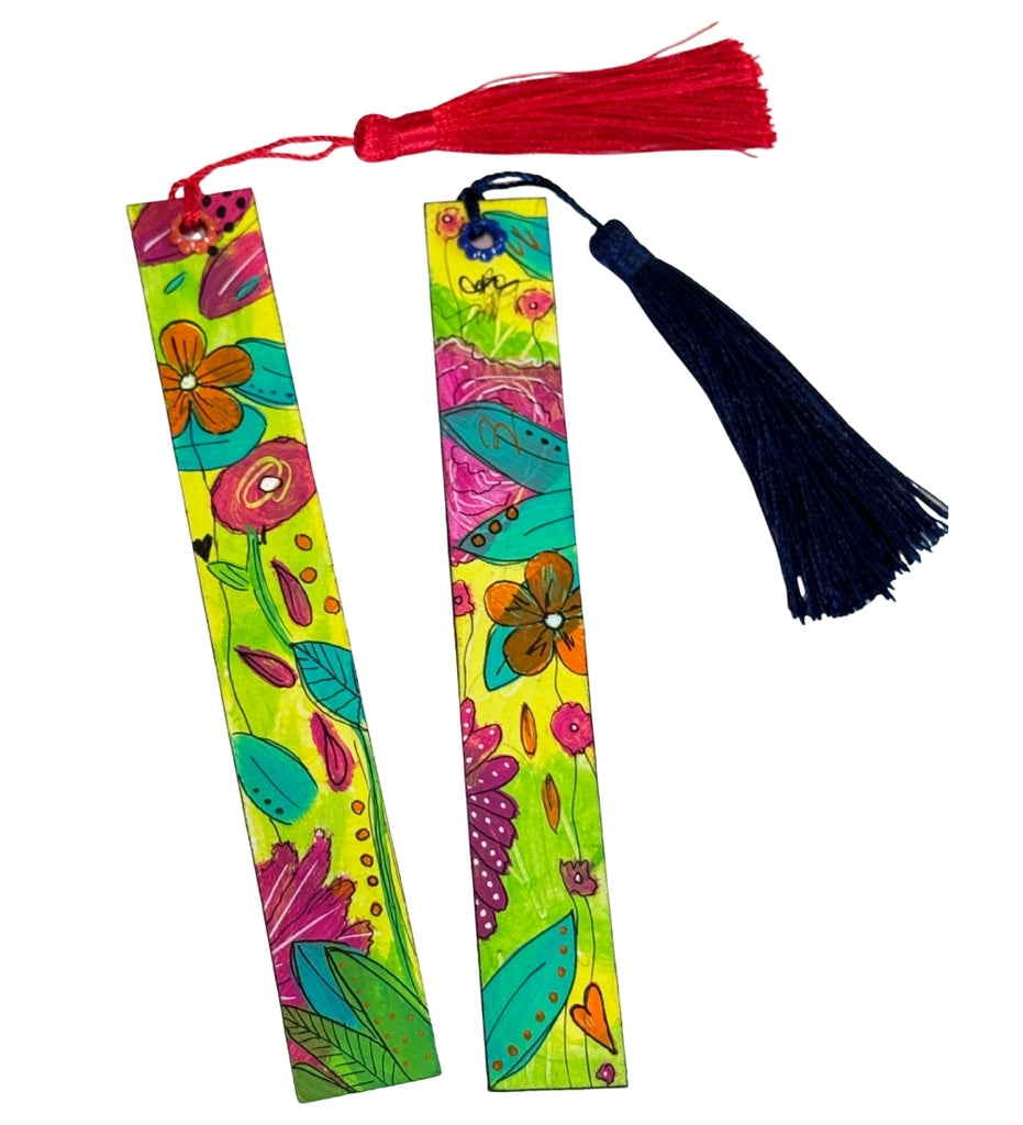 Two decorative paper bookmarks with colorful floral illustrations on a bright lime green background, one with a red tassel and one with a dark navy tassel, shown on a plain white background.