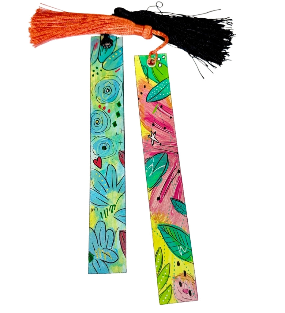 painted bookmarks with colorful floral designs and tassels at the top of each one