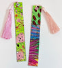 Two colorful hand-painted bookmarks with pink tassels, displayed on a plain white background.