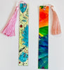 two hand painted tassel bookmarks with colorful artwork