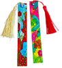 Two colorful rectangular bookmarks with tassels on a plain white background. One bookmark is cream/beige with a blue, red, and yellow floral design, and the other is bright pink with green leaves and orange flowers.