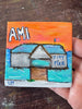 a small painting with text 'AMI City Pier' featuring a building on a pier over water with a sunset