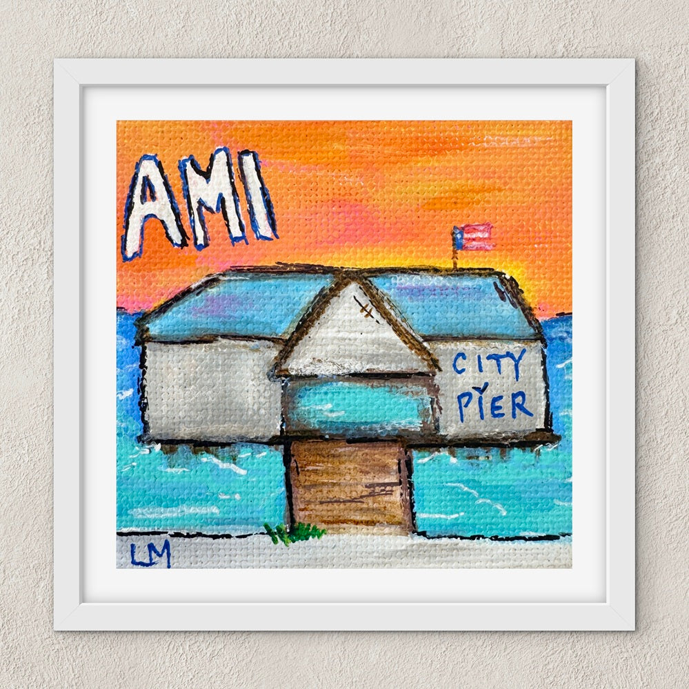 Framed artwork of a small building labeled 'City Pier' with 'AMI' text against a colorful sky.