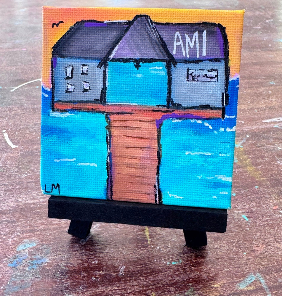 small painting with a pier and text 'AMI' with water and a sunset sky