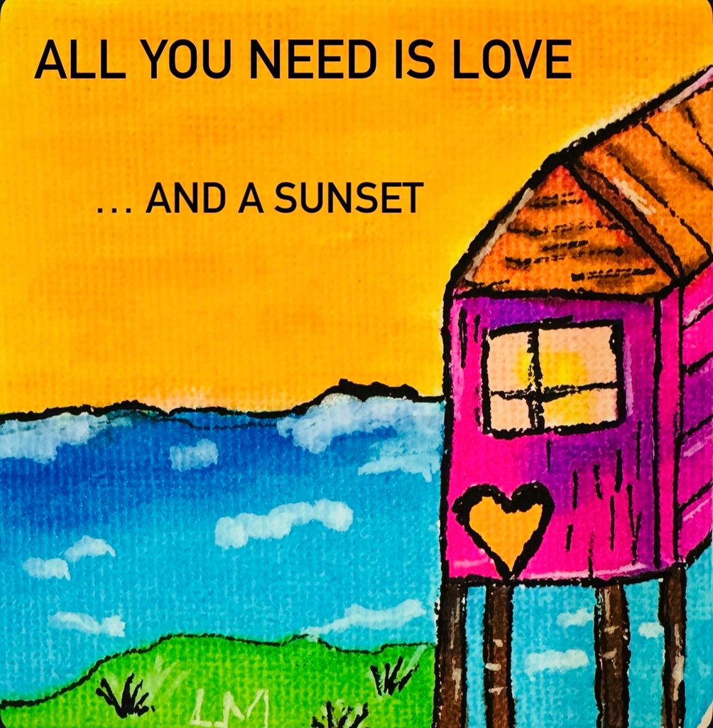 beach house with writing "All you need is love and a sunset"