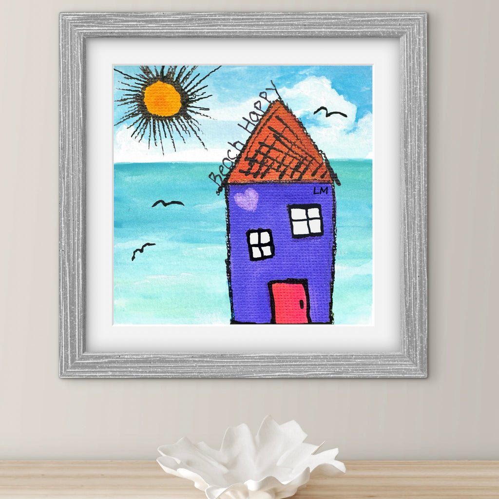 Framed drawing of a beach house with a blue sky and sun.