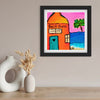 Framed artwork of a beach house with a palm tree on a wall above two vases.