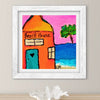 Framed artwork of a 'Beach House' with a palm tree and ocean on a pink sky.