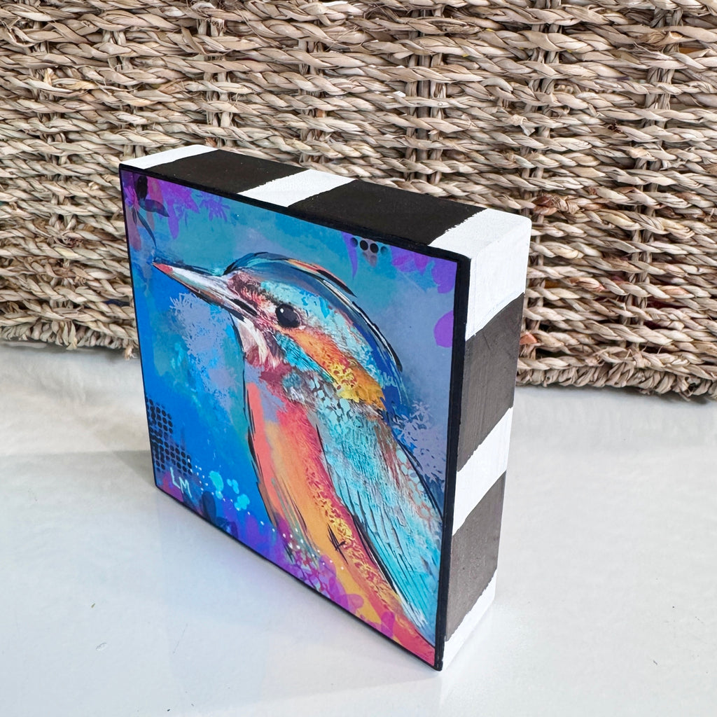 Angled view of Birds of Color art block, showing the colorful bird artwork and hand-painted black-and-white striped top and side.