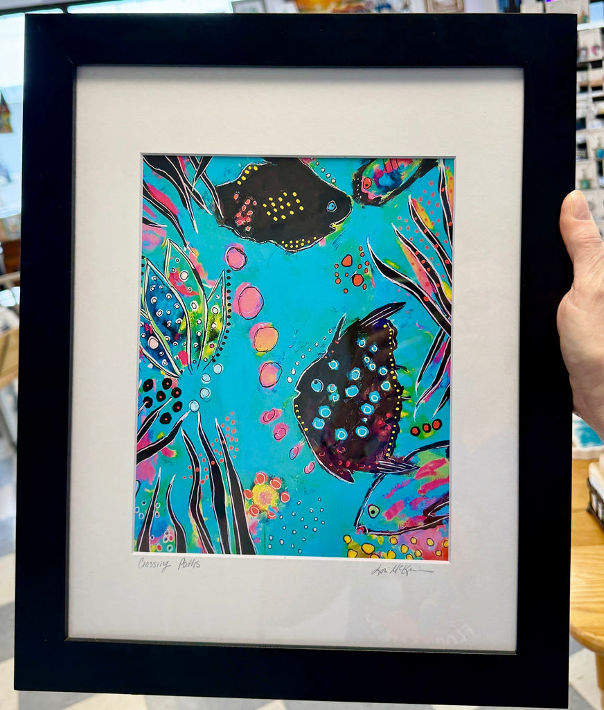 Framed colorful artwork of fish on a blue background