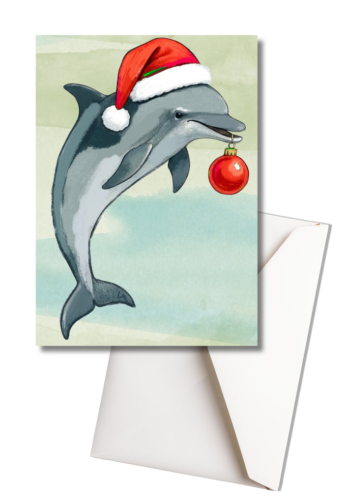 Card with a dolphin wearing a Santa hat and holding a Christmas ornament, on a light green background.