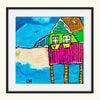 Colorful art print of a house with a black frame
