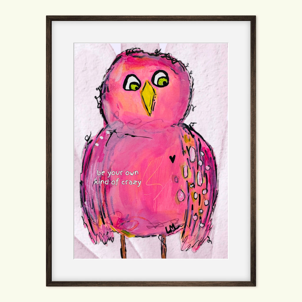 Framed artwork of a pink bird with a motivational quote on a light background