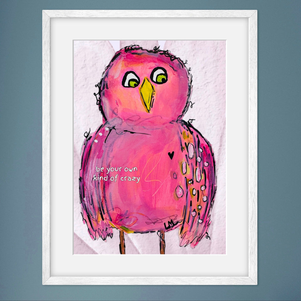 Framed artwork of a pink bird with a motivational quote in a white frame