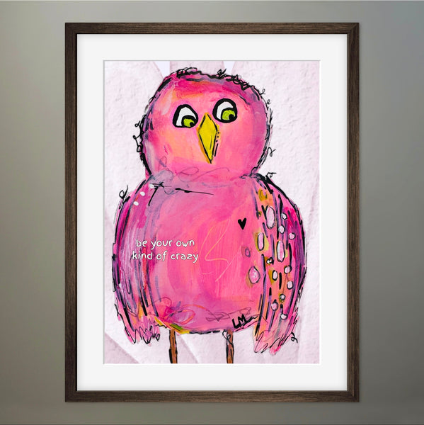 Framed artwork of a pink bird with a motivational quote on a light colored background