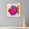Framed colorful fish artwork on a gray wall with a vase and starfish below.