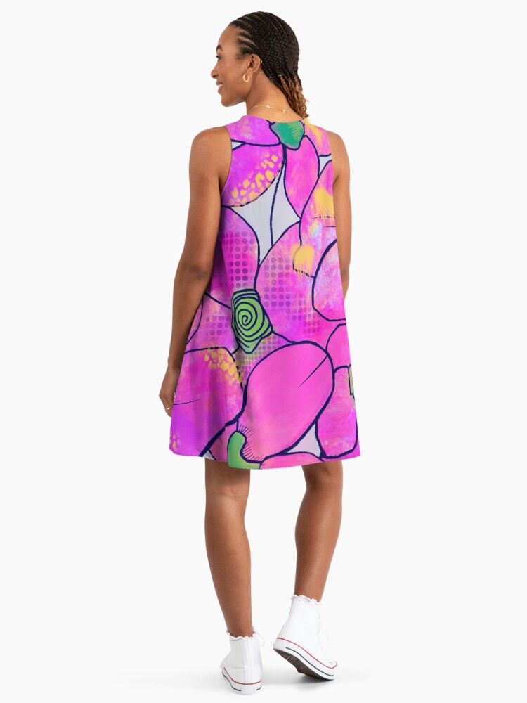 the back of a woman wearing a pink floral sleeveless dress