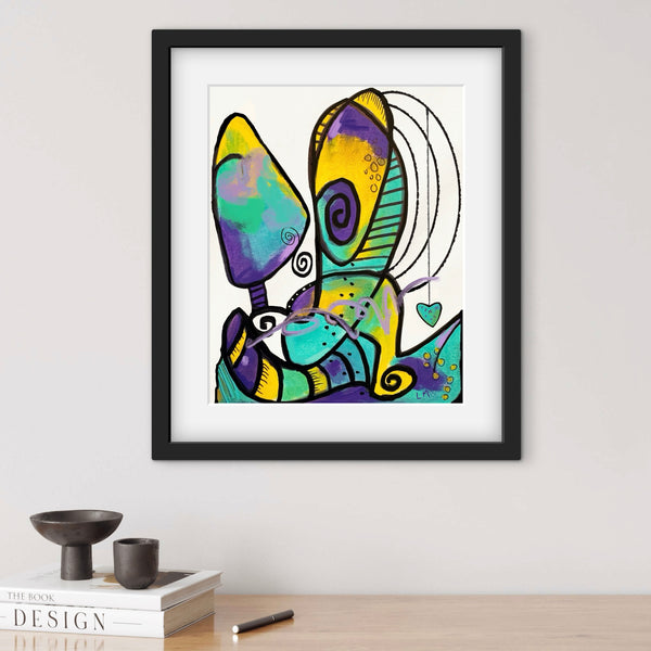 Framed abstract artwork with colorful design on a white wall.