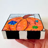 whimsical pumpkin painting on a wood block and the text 'thankful', The sides are painted with black and white stripes