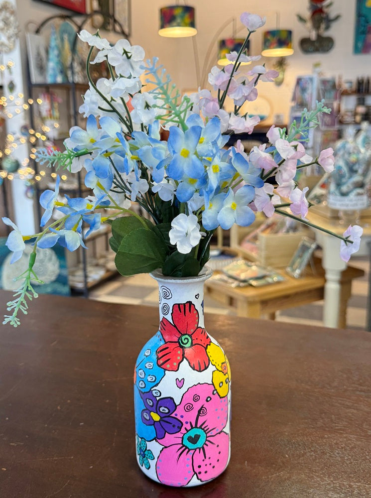 sample of vase with silk flowers in it