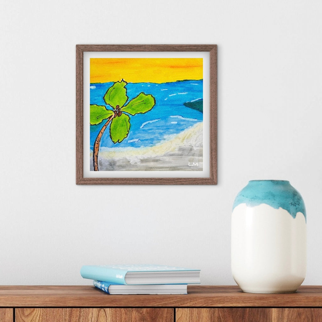 Framed beach scene painting on a wooden surface with a vase and books.