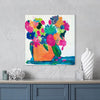 Colorful floral painting on a wall above a blue cabinet with decorative items.
