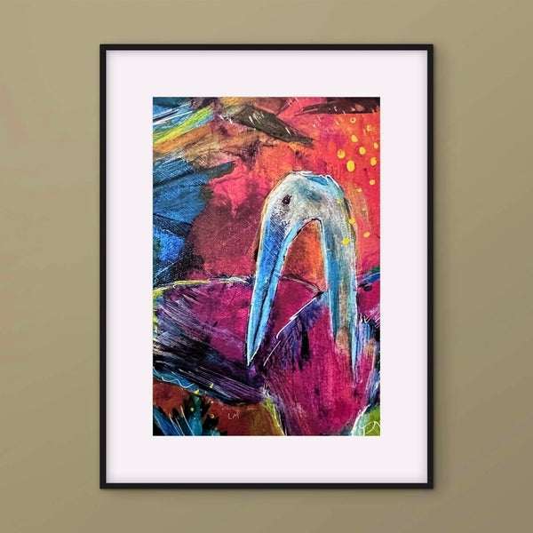 A framed abstract art print featuring a stylized bird with a pink, red, and orange background, mounted on a beige wall