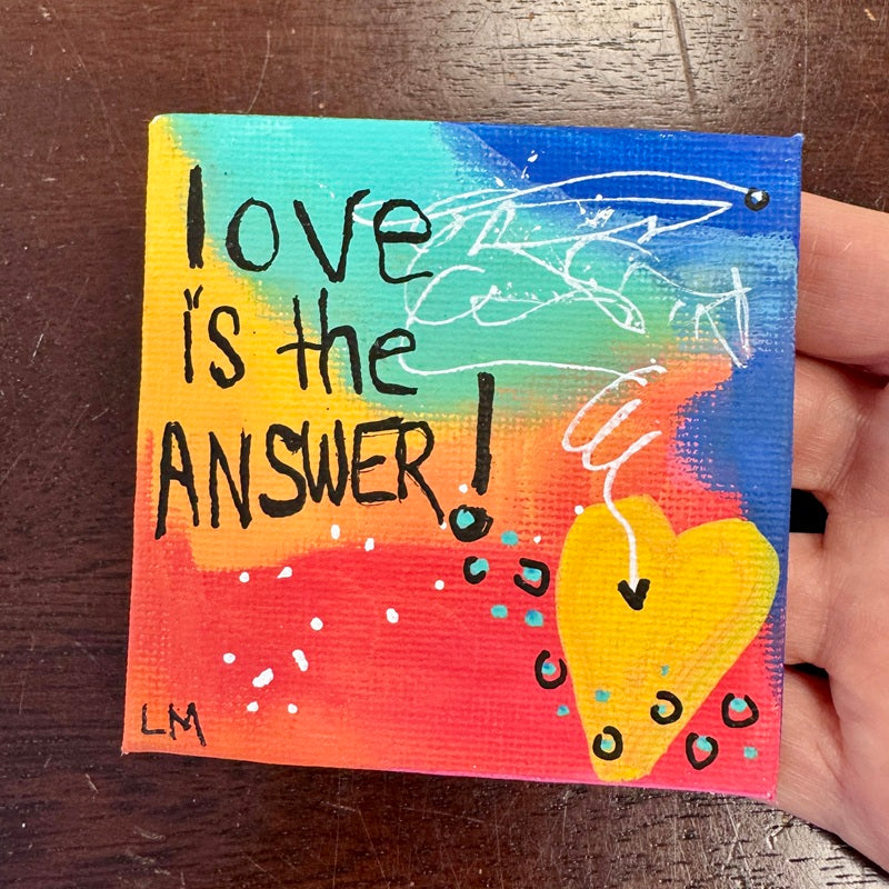square painting with "Love is the Answer" on a colorful background