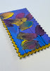 colorful small painting on a white surface