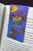 painted bookmark sitting inside a book