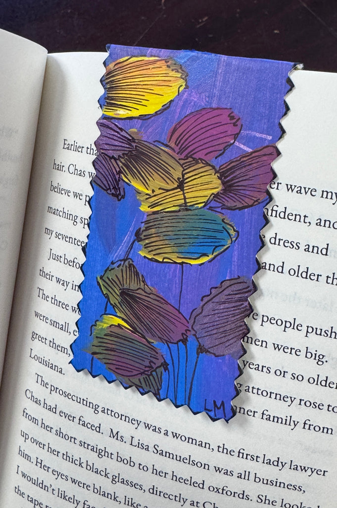 painted bookmark sitting inside a book