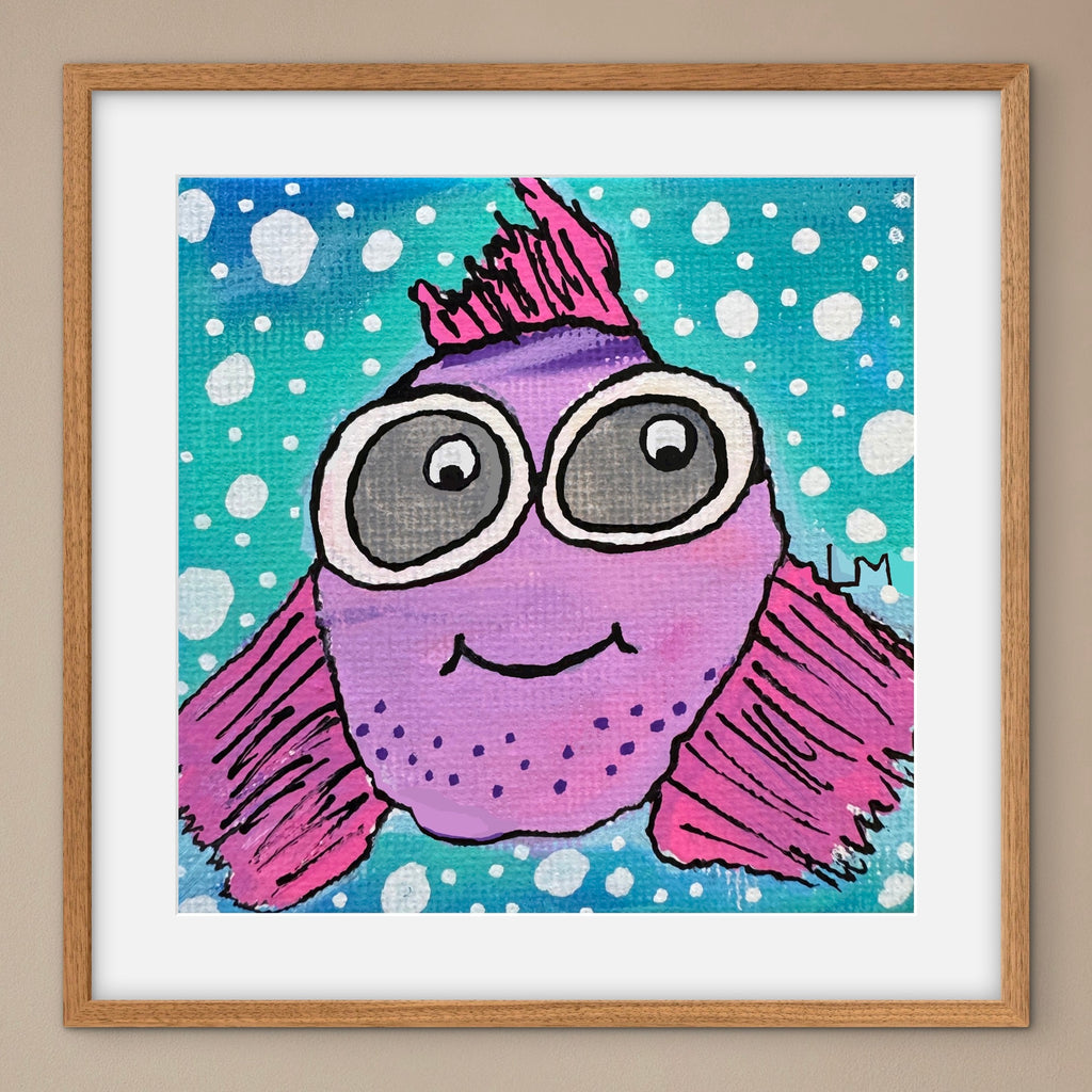 Framed artwork of a purple fish with goggles on a blue background with white polka dots.