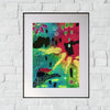 colorful abstract painting in a frame with a white mat hanging on a white brick wall