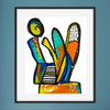 Framed abstract artwork with colorful shapes on a blue wall