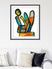 Framed abstract artwork on a wall above a sofa with cushions.