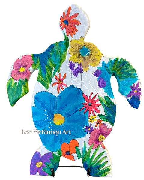 Colorful turtle-shaped art piece with floral patterns on a white background, featuring the artist's name 'Lori McKinnon Art'.