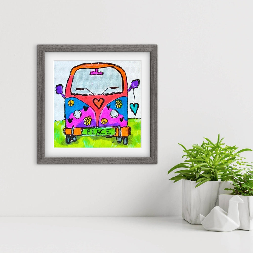 Framed artwork of a colorful VW van with 'peace' text on a white wall.