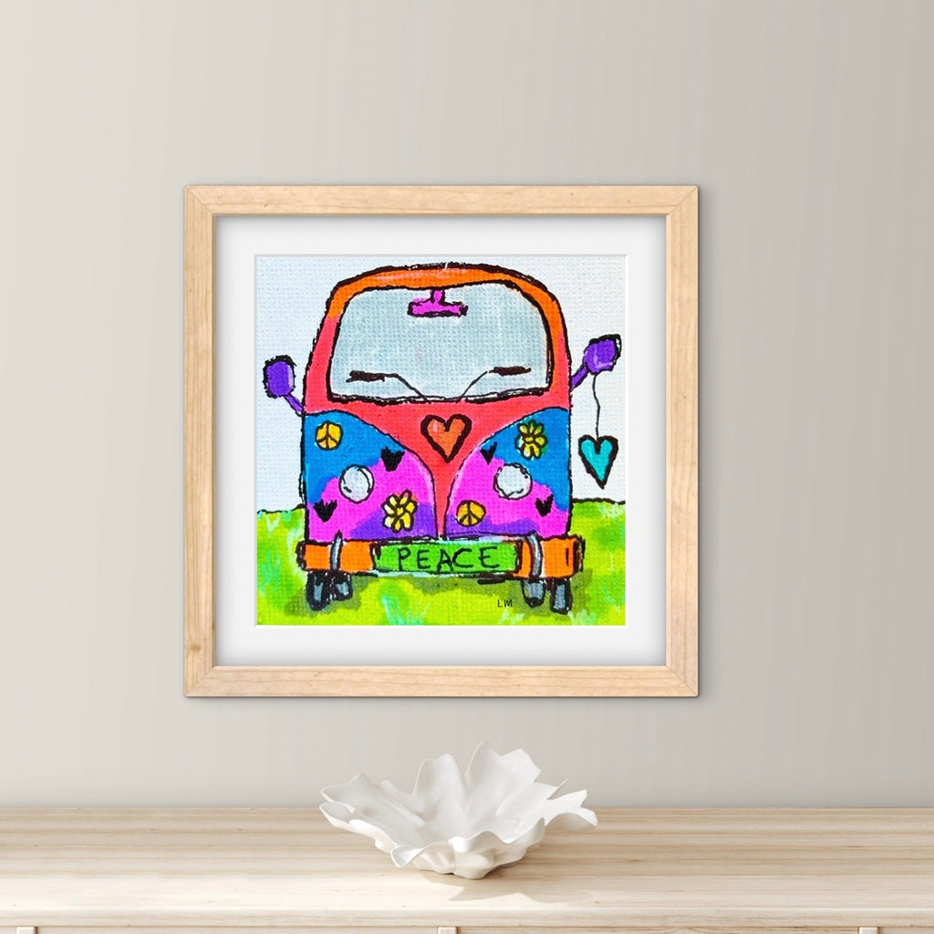 Framed artwork of a colorful van with peace symbols on a wall.