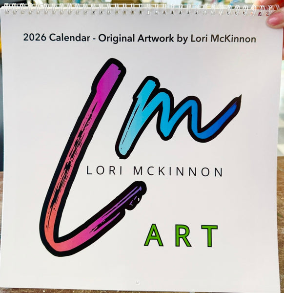 2026 calendar with colorful 'Lori McKinnon Art' logo held by a hand.