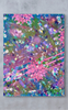 Colorful abstract painting with pink flowers on a gray wall