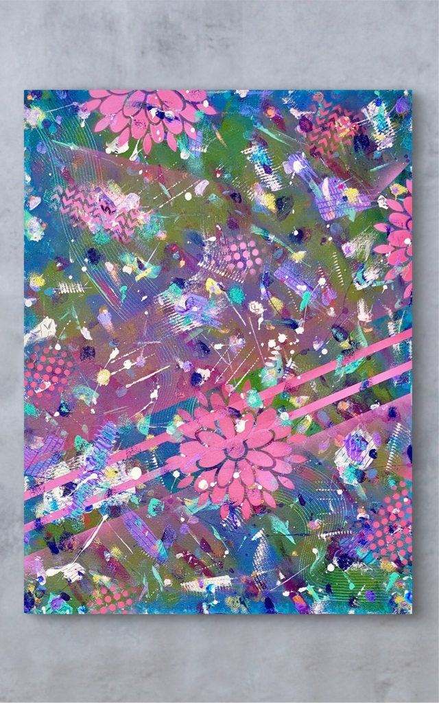 Colorful abstract painting with pink flowers on a gray wall