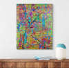 Abstract painting with colorful brush strokes on a wall above a wooden shelf.