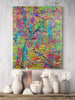 Colorful abstract painting on a wall above a wooden shelf with decorative items.
