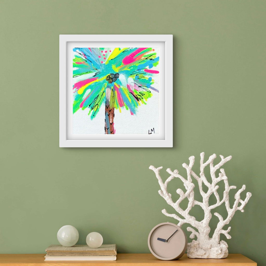 Framed colorful abstract painting on a green wall with decorative items below.