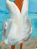 Close-up of a seagull on a beach with a blue sky background