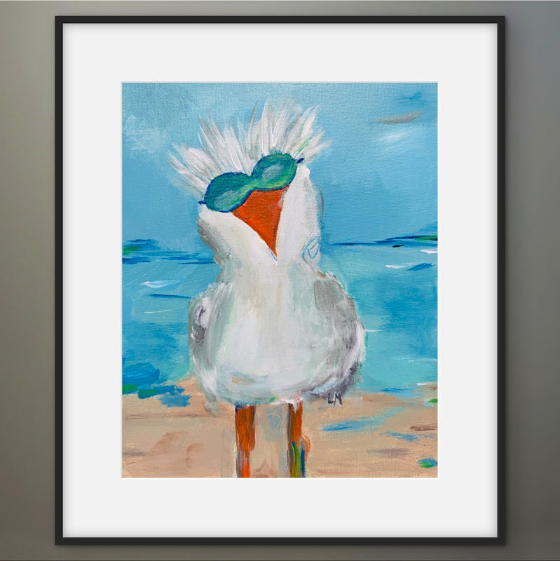 Framed painting of a seagull on a beach with a blue sky.