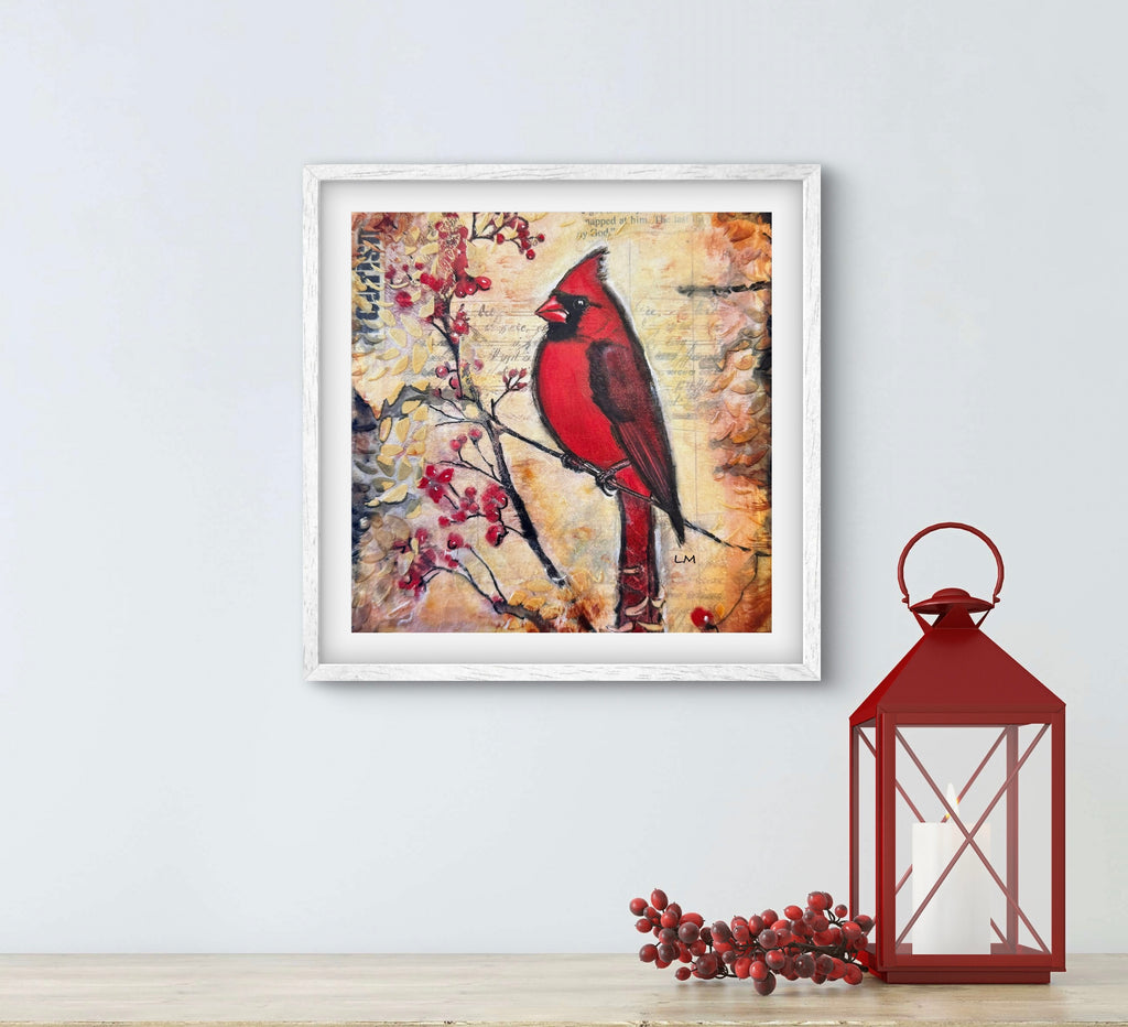 Framed artwork of a red cardinal bird on a branch with berries, next to a red lantern and decorative branches on a light blue wall.