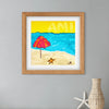 Framed artwork of a beach scene with an umbrella, sand, and starfish on a gray wall.